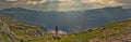 Girl looking at a picturesque view of the  fjord underneath close to Trolltunga Royalty Free Stock Photo