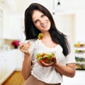 Girl looking positive and holding a bawl with salad