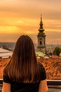 Girl looking at Saborna Church at sunset in Belgrade