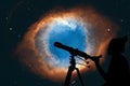 Girl looking at the stars with telescope. The Helix Nebula Royalty Free Stock Photo