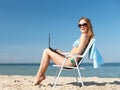 Girl looking at tablet pc on the beach Royalty Free Stock Photo