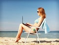 Girl looking at tablet pc on the beach Royalty Free Stock Photo
