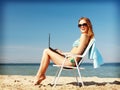 Girl looking at tablet pc on the beach Royalty Free Stock Photo