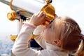 Girl looking through a telescope Royalty Free Stock Photo