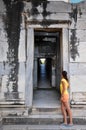 Girl Looking Through Temple Door