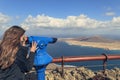 Girl looking through tourist telescope, Girl Watching the sea landscape in the observation binoculars