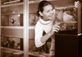 Girl looking at young fishes in aquarium Royalty Free Stock Photo