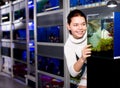 Girl looking at young fishes in aquarium Royalty Free Stock Photo