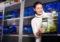 Girl looking at young fishes in aquarium Royalty Free Stock Photo