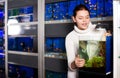 Girl looking at young fishes in aquarium Royalty Free Stock Photo