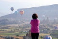 Girl looks at the flight of balloons in Cappadocia. Turkey