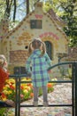 Girl looks at the house of the Little Red Riding Hood in Efteling Park in the Holland Royalty Free Stock Photo