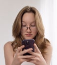 The girl looks indignantly at the smartphone Royalty Free Stock Photo