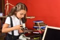 Girl looks into microscope, copy space. Science and study time Royalty Free Stock Photo