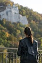 Girl looks at the park and the monastery. Young beautiful woman resting outdoor. Back view Royalty Free Stock Photo