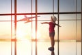 Girl looks at a plane at the airport Royalty Free Stock Photo