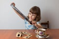 Girl looks through slides while sitting at the table