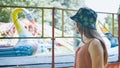 A girl looks at a working ride in a children& x27;s park. Royalty Free Stock Photo