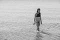 Girl with loose hair walks in sea. Royalty Free Stock Photo