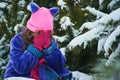 Girl lost in winter forest. lost in the woods and has a frightened face. Child crying in the forest Royalty Free Stock Photo