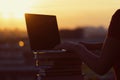 Girl with a lot of books and laptop on sunset background. Preparation for university exams. education concept Royalty Free Stock Photo