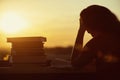 Girl with a lot of books on sunset background. Preparation for university exams. education concept Royalty Free Stock Photo