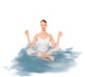 Girl in lotus pose meditating with blue cloud