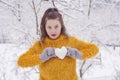 Girl with love snow ball in shape of heart