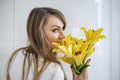 Girl in love, young and fit , beautiful woman with a yellow flower - daffodil. Romantic pose.