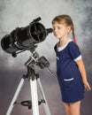 Girl lover of astronomy with interest looks in the eyepiece of the telescope Royalty Free Stock Photo