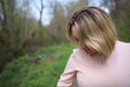 Girl lowered her head to the bottom and shows her hair to the camera