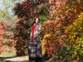 Girl with the luggage on country road in the forest Royalty Free Stock Photo