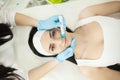 Girl lying in beauty spa enjoying skin therapy using current treatment Royalty Free Stock Photo