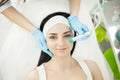 Girl lying in beauty spa enjoying skin therapy using current treatment Royalty Free Stock Photo