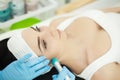 Girl lying in beauty spa enjoying skin therapy using current treatment Royalty Free Stock Photo