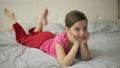 Girl lying on the bed moves feet