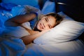 A girl is lying in bed and smiling. calm and healthy children`s sleep