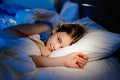 A girl is lying in bed and smiling. calm and healthy children`s sleep