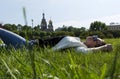 girl lying in a clearing among the green grass, on the background of the Church of the Savior on blood