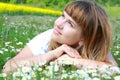 Girl lying on the grass with daisy flowers