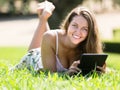 Girl lying on grass with ereader