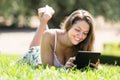 Girl lying on grass with ereader