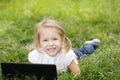 Girl lying on the grass with laptop Royalty Free Stock Photo