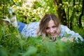 Girl lying on the grass in the park with flowering Apple trees in a spring time Royalty Free Stock Photo