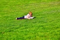 Girl lying on grass and reading