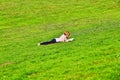 Girl lying on grass and reading