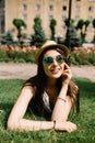 Girl lying on grass and talking on phone Royalty Free Stock Photo