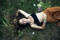 A girl is lying on the green grass, a picture from above. Royalty Free Stock Photo