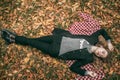 The girl is lying on the ground in the leaves Royalty Free Stock Photo