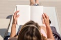 Girl lying reading a book